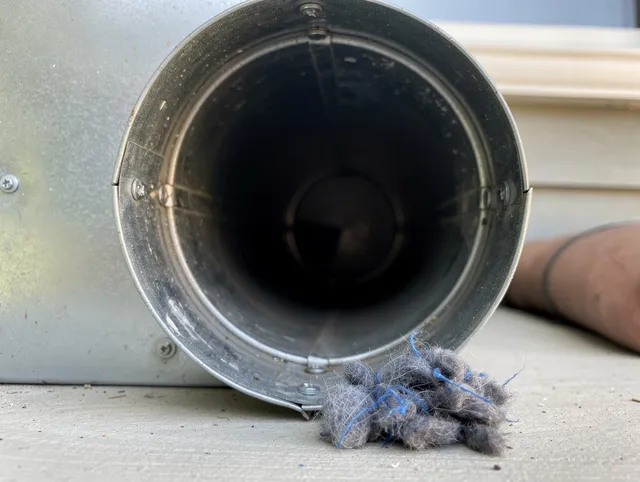 Bay Village Dryer Vent Cleaning technician using specialized equipment to clear severe dryer vent blockage in Bay Village